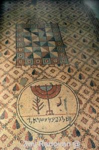 1413. JERICHO, MOSAIC FLOOR OF THE 5TH. C. SYNAGOGUE DEPICTING THE 7 BRANCHED CANDELABRA (MENORAH) INSCRIBED "PEACE ON ISRAEL"  (SHALOM AL ISRAEL) © <i> synagogues.kinneret.ac.il </i>